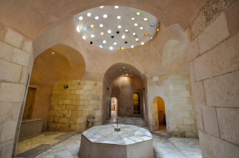 an inside view of a long building with lights in the ceiling