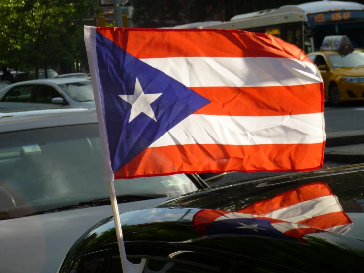 a car in a parking lot with a puerto flag on it