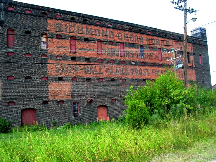 an abandoned building that has some red shutters