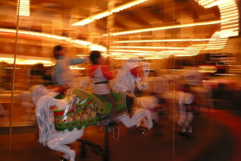 a merry go round with people riding on it