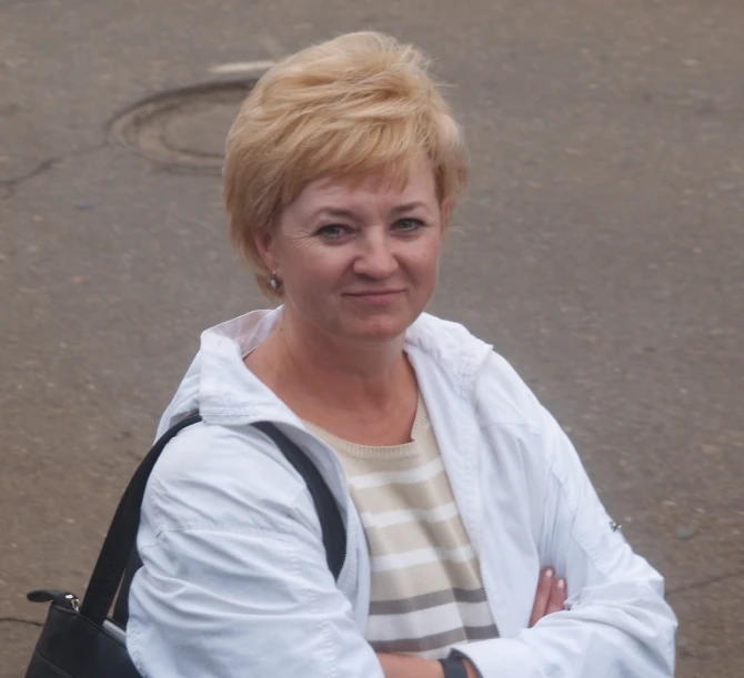 a woman with a handbag looking at the camera