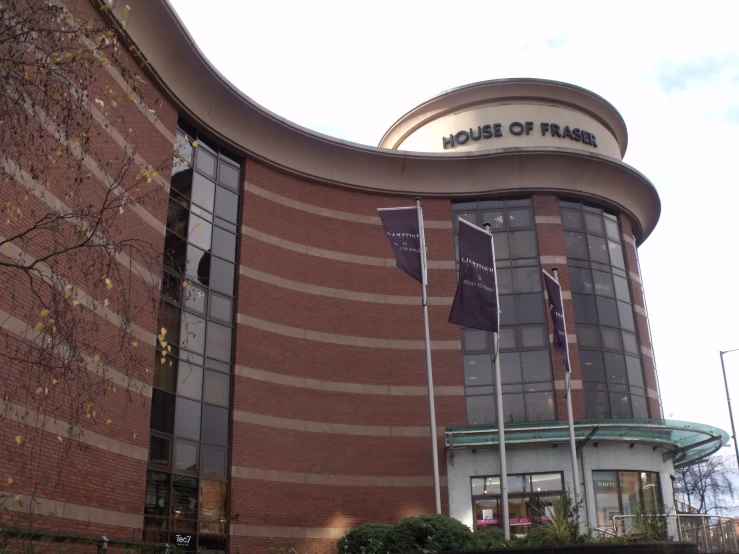 a large brick building with flags attached to the outside