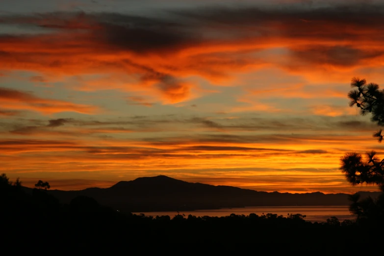 the orange and yellow clouds are lit by a setting sun