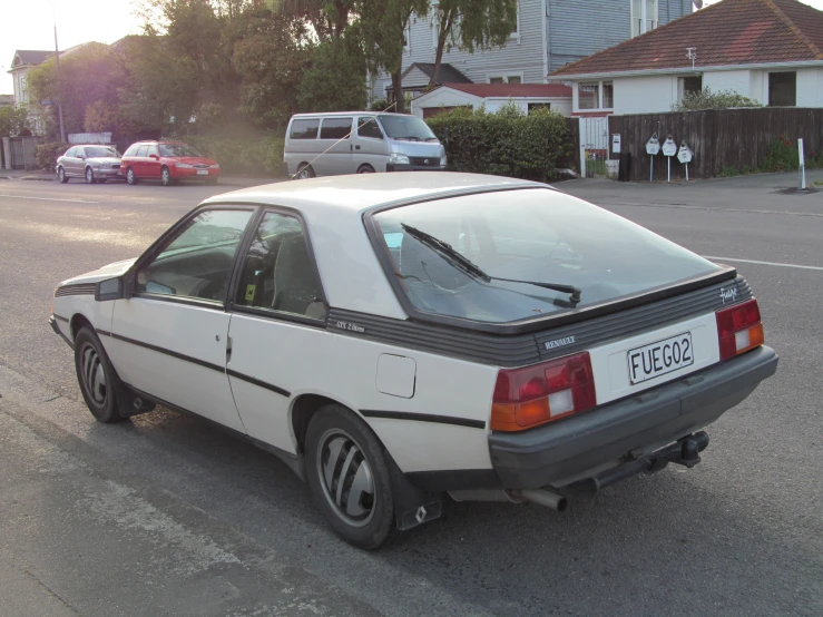 the car is parked next to the driveway