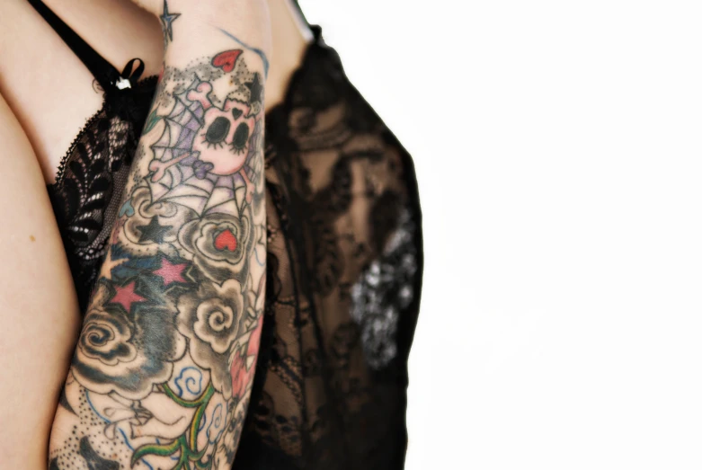 close up image of a woman with lots of tattooed arms