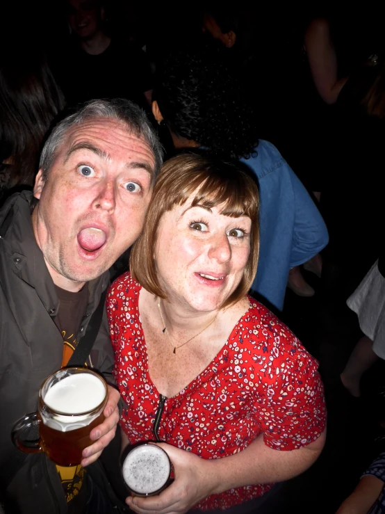 a man and woman are drinking some beer