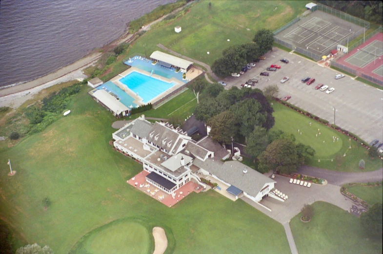 a house and an open pool next to the water