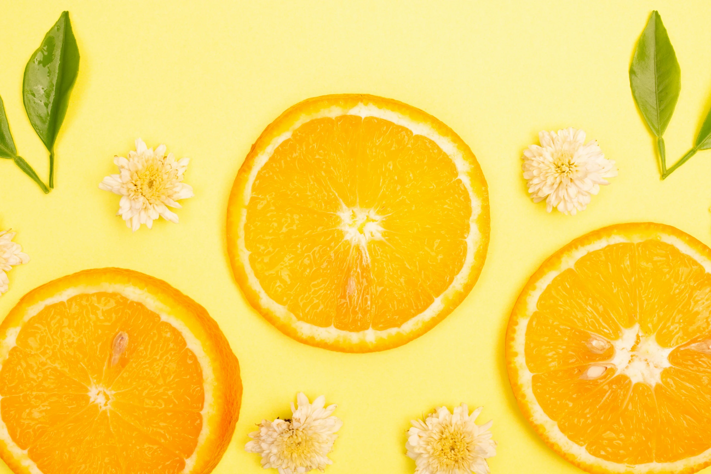 orange slices with leaves and flowers on a yellow background, trending on pexels, background image, photoshoot for skincare brand, thumbnail, grey orange