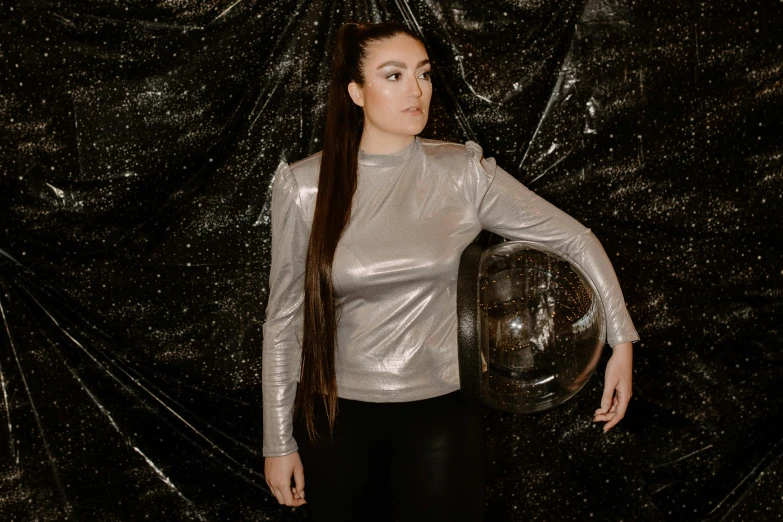 a woman with a helmet posing for a picture, an album cover, inspired by Eve Ryder, pexels contest winner, metallic flecks, sasha grey, lunar themed attire, thicc