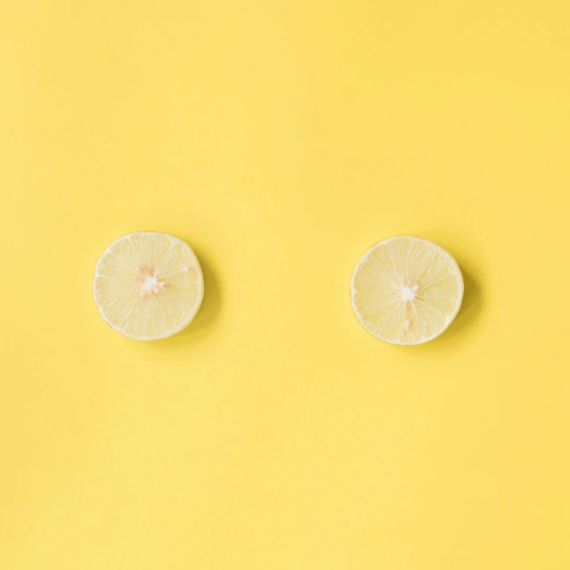 two slices of lemon on a yellow background, trending on pexels, postminimalism, nendoroid eyes, bare midriff, wall of eyes, 🍸🍋