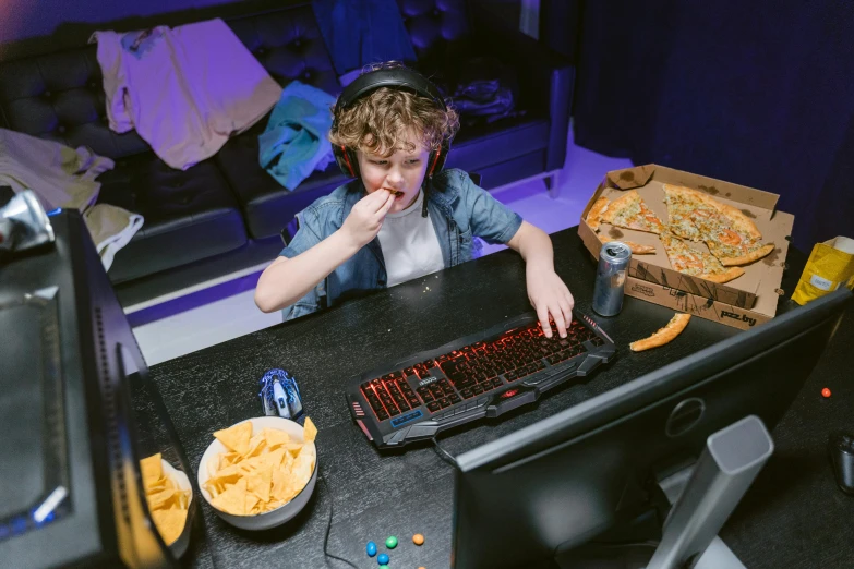 a young boy sitting at a desk in front of a computer, pexels, mukbang, activision blizzard style, dnd), weta digital