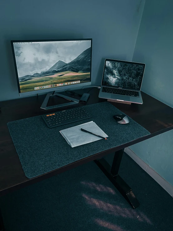 a desktop computer sitting on top of a wooden desk, on a table