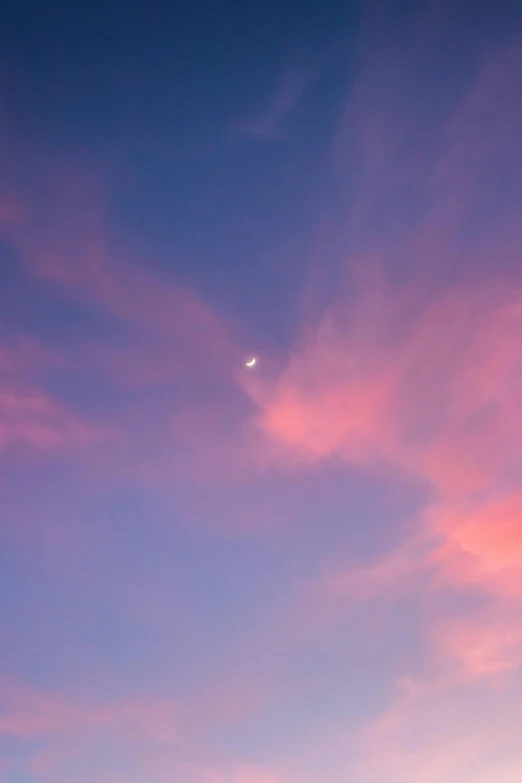 a plane that is flying in the sky, by Julian Allen, aestheticism, crescent moon, pink sunset, color photograph, 1 2 9 7