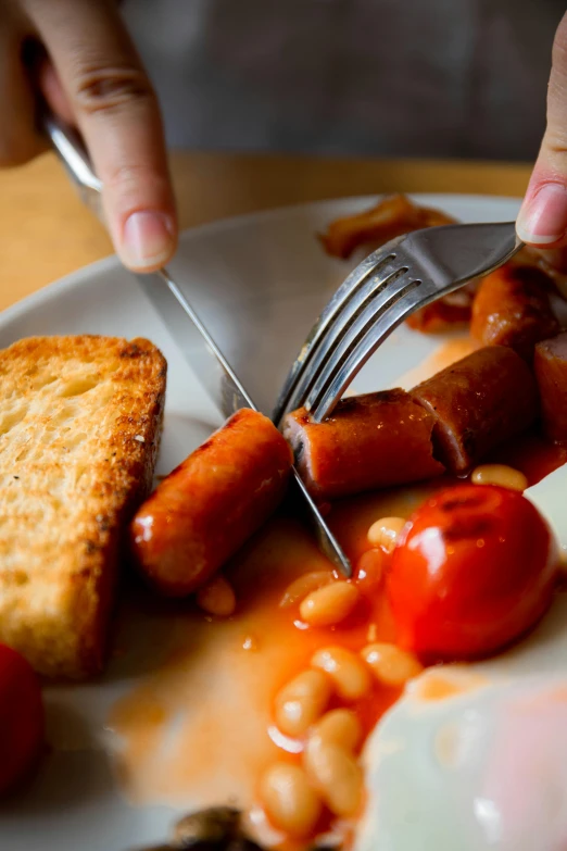 a person holding a fork and knife over a plate of food, by Sven Erixson, pexels contest winner, photorealism, sausages, britain, wake up, twas brillig