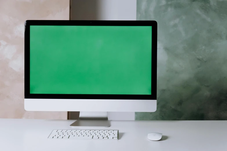 a computer with a green screen sitting on a desk, inspired by Elsa Bleda, trending on pexels, computer art, white hue, green square, no - text no - logo, apple design