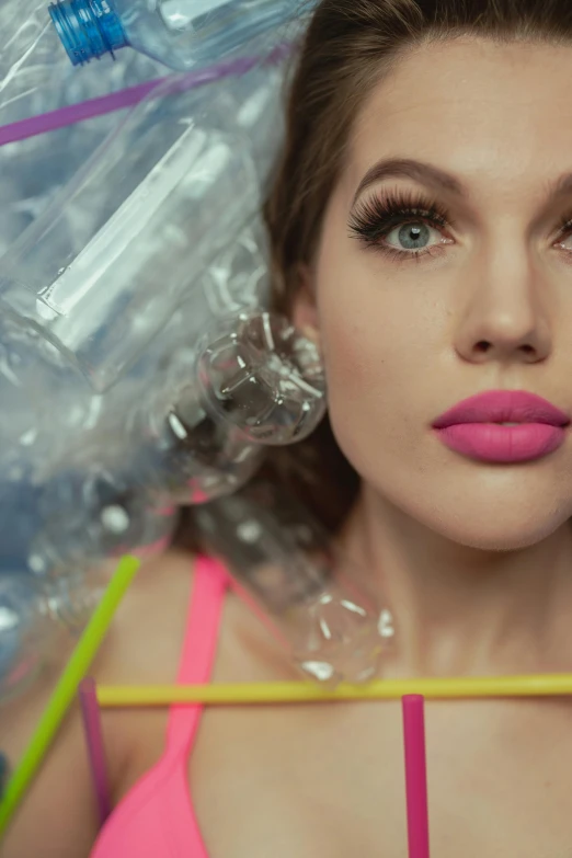 a woman with a bunch of plastic bottles on her head, an album cover, inspired by David LaChapelle, trending on pexels, plasticien, hailee steinfeld, puffy lips, super slowmotion, gif