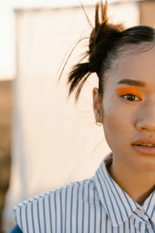 a woman with an orange eye shadow on her face, trending on pexels, ashteroth, half asian, sundown, teenage girl