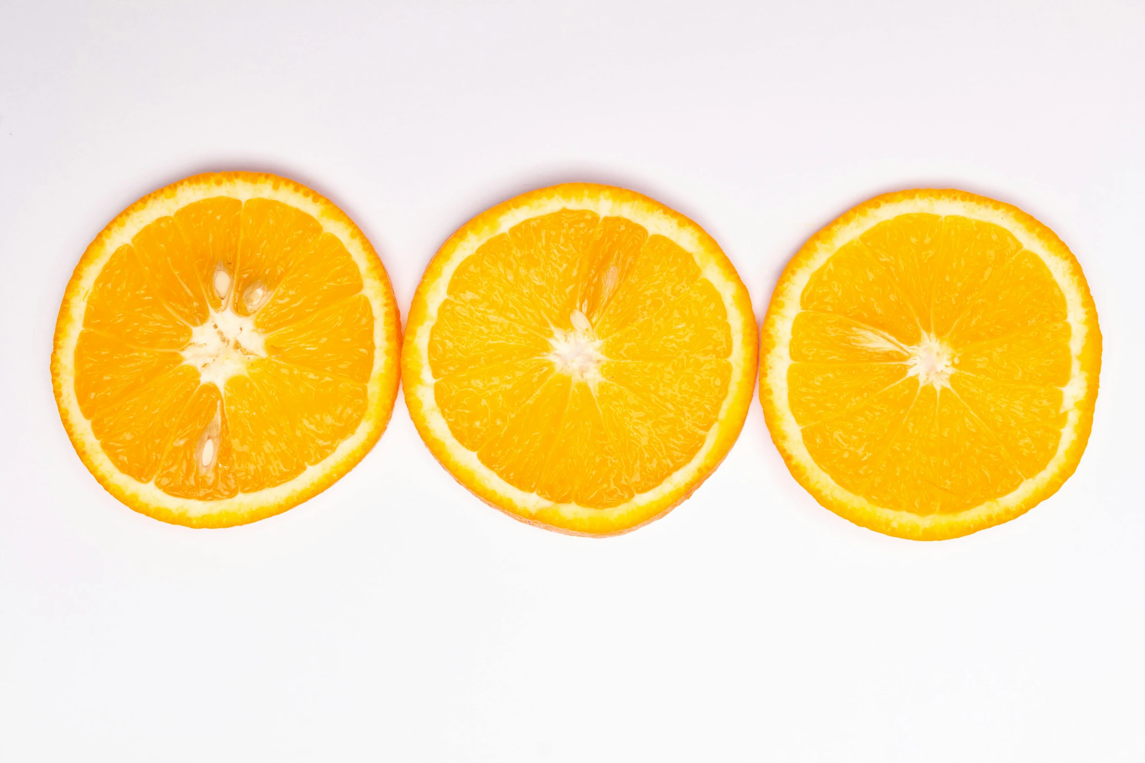 three oranges cut in half on a white surface, by Gavin Hamilton, pexels, minimalism, 🦩🪐🐞👩🏻🦳, yellow-orange, in a row, low ultrawide shot