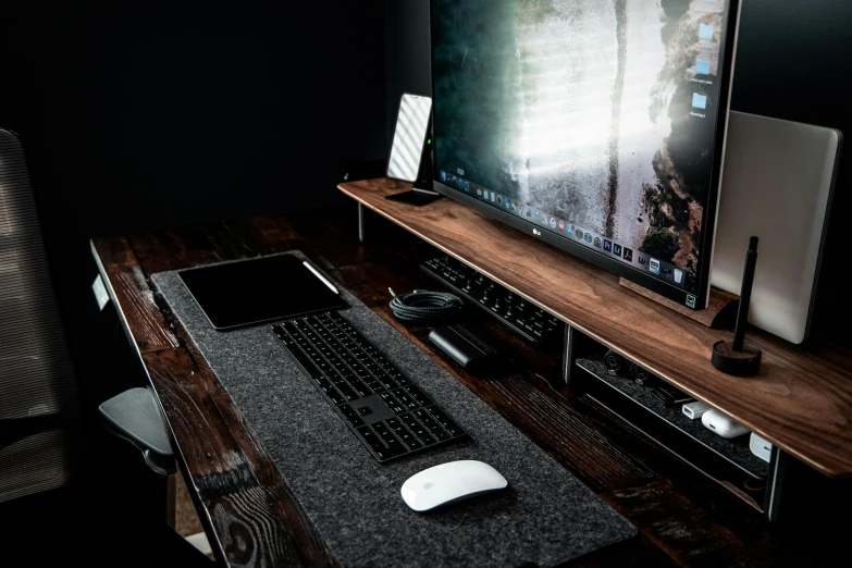 a computer monitor sitting on top of a wooden desk, dark grey carpet, gaming table, detailed product image, portrait shot