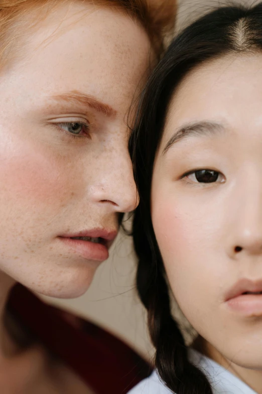 a couple of women standing next to each other, trending on pexels, realism, pale thin lips, asian male, freckled pale skin, editorial model