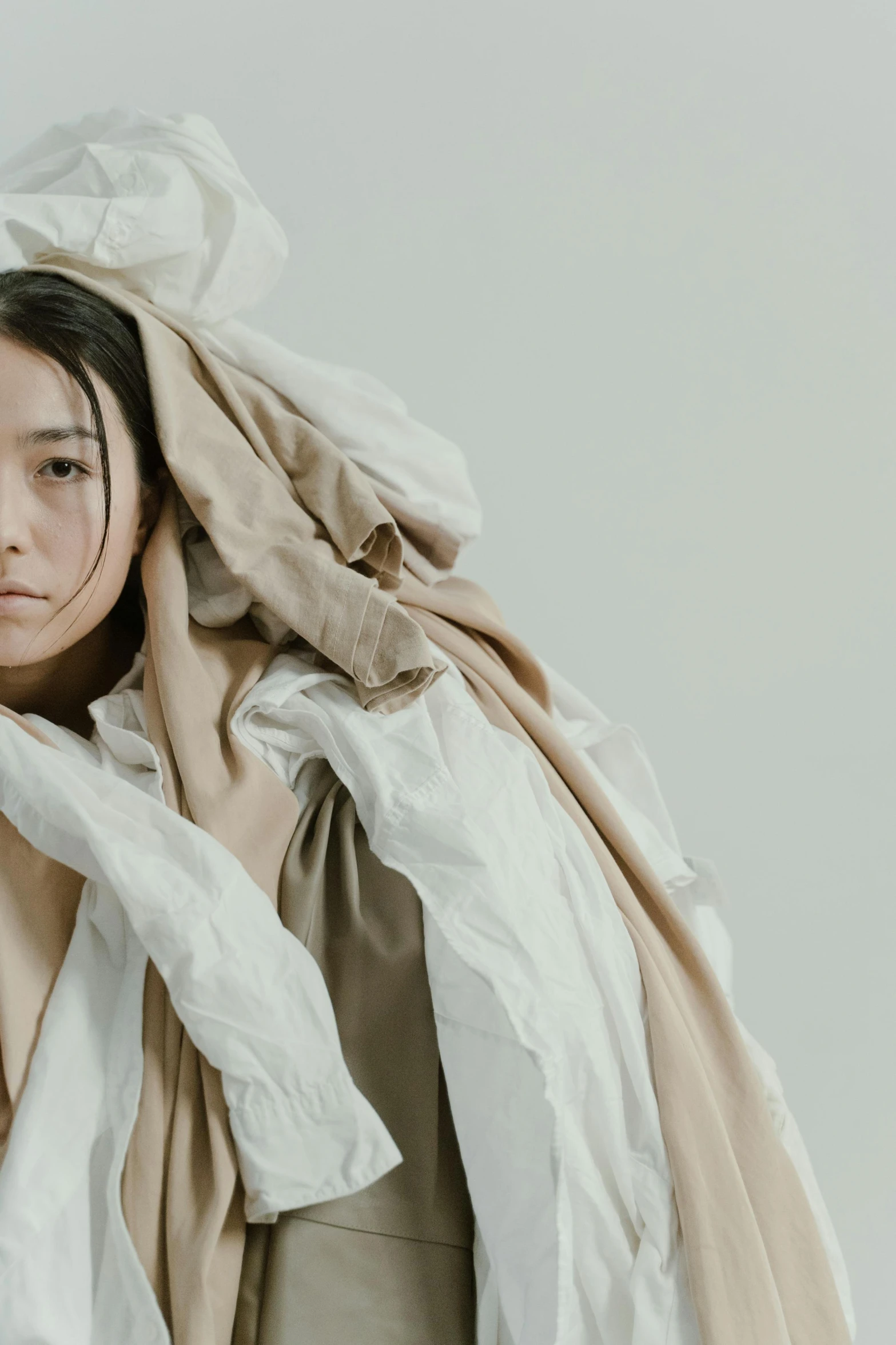 a woman is wrapped up in a blanket, inspired by Kim Tschang Yeul, unsplash, gutai group, multilayered outfit, neutral tones, frill, japanese clothes