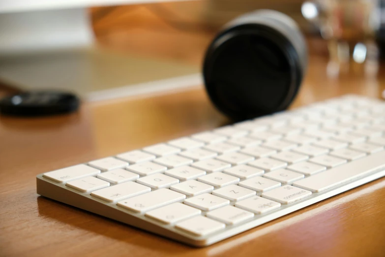 a computer keyboard sitting on top of a wooden desk, by Carey Morris, unsplash, glossy white metal, background image, shot on sony a 7, rectangle