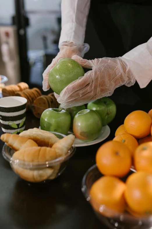 a person in a white shirt and black apron holding an apple, a still life, unsplash, process art, breakfast buffet, wearing gloves, plastic wrap, city morning