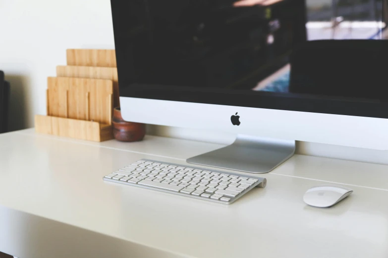 a computer monitor sitting on top of a white desk, by Carey Morris, pexels, apple, keyboard, ignant, close up portrait shot