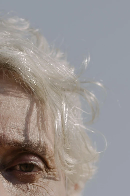 a close up of a person with white hair, inspired by Cindy Sherman, hair over her eyes, photographed for reuters, album cover, low view