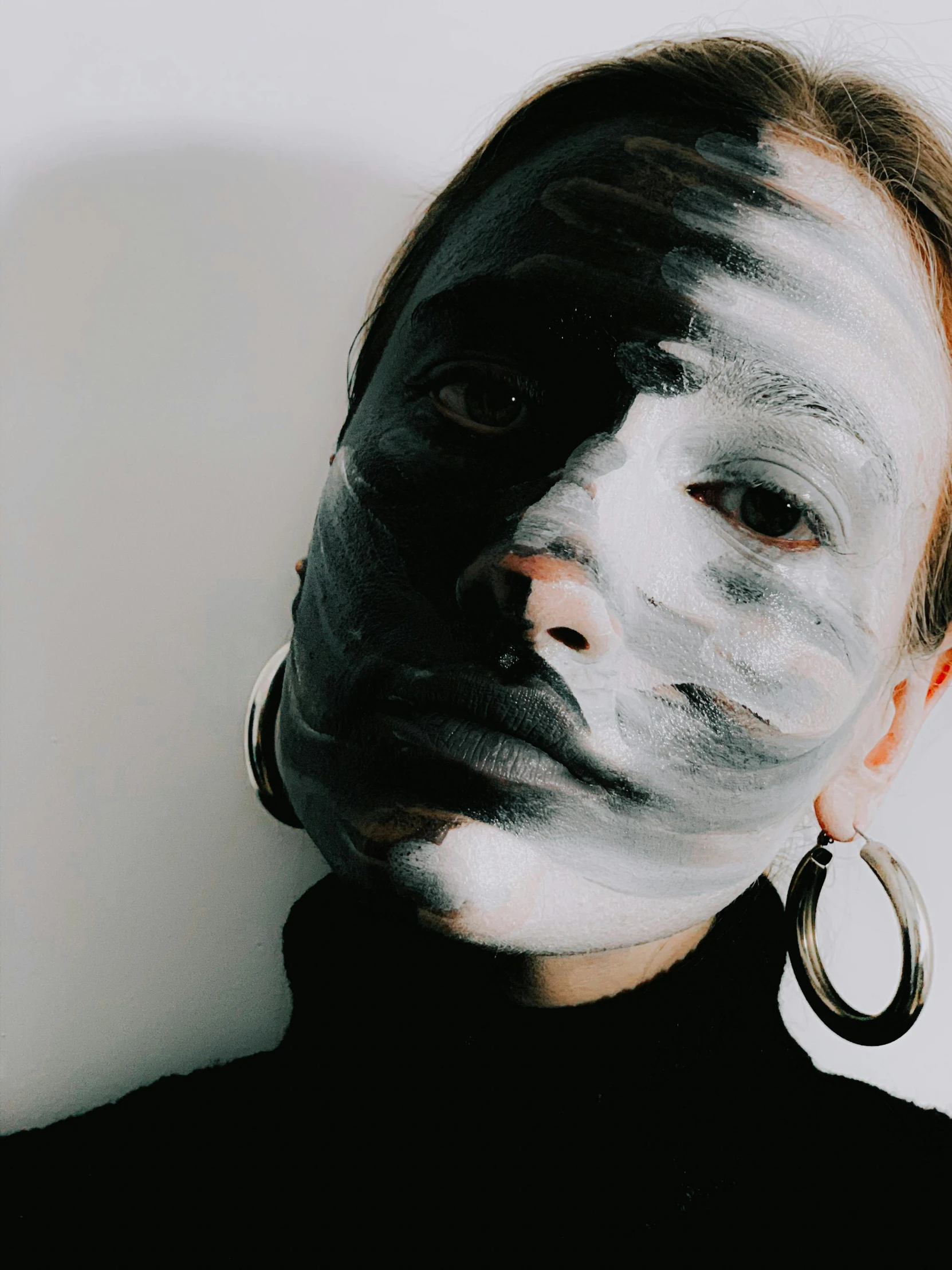 a woman with white paint on her face, inspired by Taro Yamamoto, trending on pexels, dressed in a gray, face covers half of the frame, instagram photo, instagram story