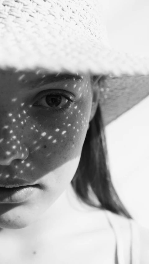 a close up of a person wearing a hat, inspired by Max Dupain, stargazer, young girl, sunlight filtering through skin, spots