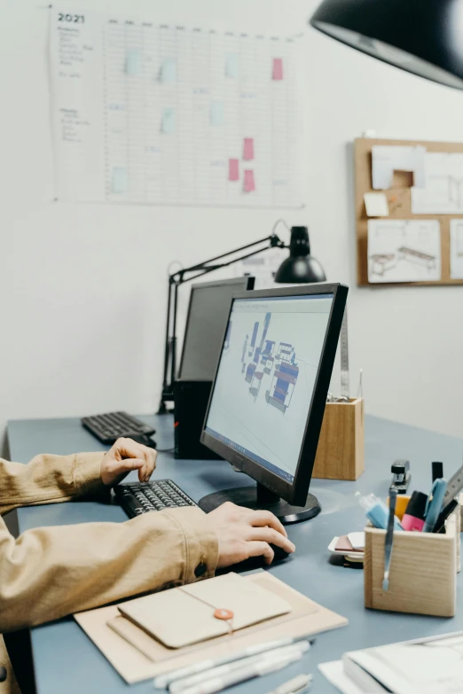 a man sitting at a desk using a laptop computer, a computer rendering, trending on pexels, industrial design, sat at her desk, built on a small, blue print