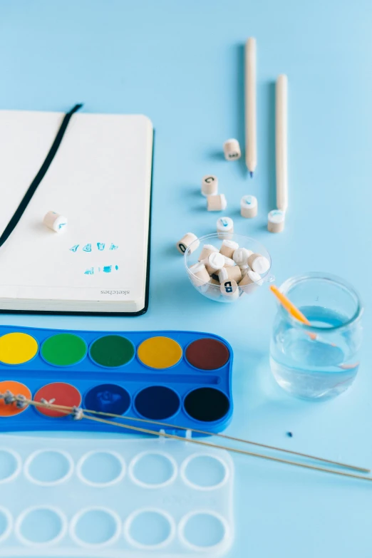 a close up of a bunch of items on a table, a child's drawing, trending on pexels, blue white colors, water particules, creative coding, studio product shot