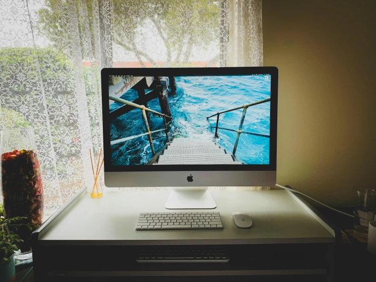 a computer monitor sitting on top of a desk, inspired by Elsa Bleda, unsplash, on a rainy day, mac, pinterest wallpaper, bay area