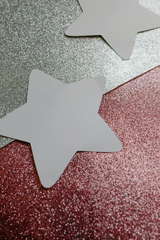 three white stars on a red and silver background, glitter sticker, detail shot, rebecca sugar, medium close shot