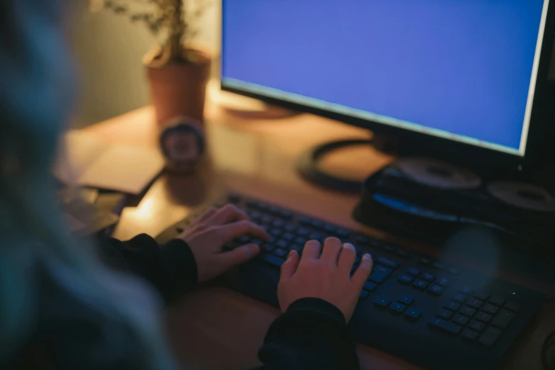 a person typing on a keyboard in front of a computer, pexels, it's night, avatar image, wide shot, student