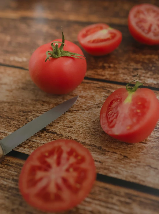 a bunch of tomatoes sitting on top of a wooden table, holding a kitchen knife, avatar image, multiple stories, profile image