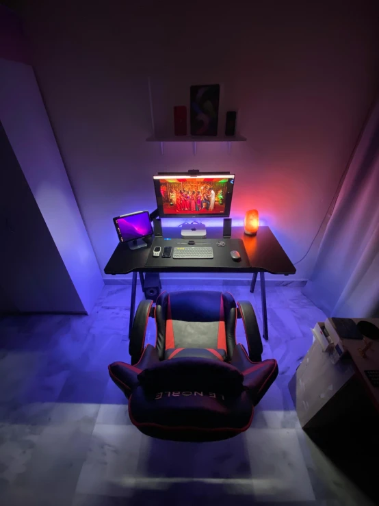 a computer desk with a gaming chair in front of it, by Adam Marczyński, featured on reddit, light and space, purple and red, cheerful ambient lighting, taken on iphone 1 3 pro, wide high angle view