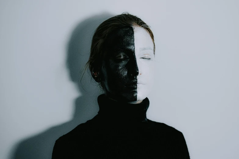 a woman with black paint on her face, a black and white photo, pexels contest winner, antipodeans, half robot and half woman, symmetrical face and full body, shadowed face, eyeless