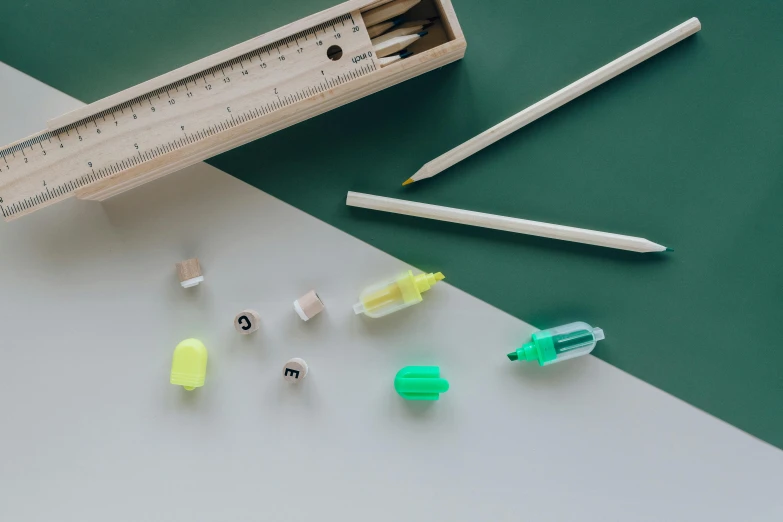 a close up of a box of pencils and a ruler, a still life, inspired by Damien Hirst, unsplash, light green, miniature product photo, white neon, various items