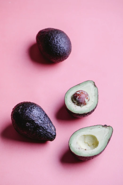 avocados on a pink background, a picture, by Kristin Nelson, pexels, shot on hasselblad, raw file, hispanic, 278122496