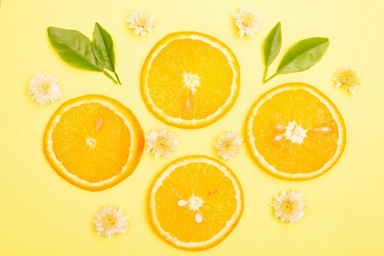 orange slices with leaves and flowers arranged in a circle, trending on pexels, yellow backdrop, 🦩🪐🐞👩🏻🦳, soft bright skin, facebook post