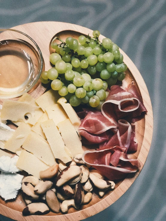 a close up of a plate of food on a table, inspired by Albert Paris Gütersloh, pexels contest winner, renaissance, 🐿🍸🍋, cheesy, grapes, high quality product image”