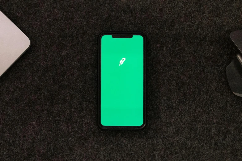 a close up of a cell phone with a green screen, a minimalist painting, by Stephen Greene, trending on pexels, tachisme, corporate phone app icon, on black paper, green feathers, minimalist sticker