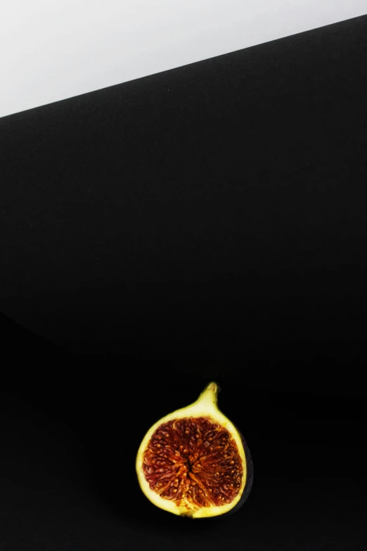 a fig sitting on top of a black table, inspired by Robert Mapplethorpe, minimalism, 256x256, slice of life”, aida muluneh, closeup!!!!!!