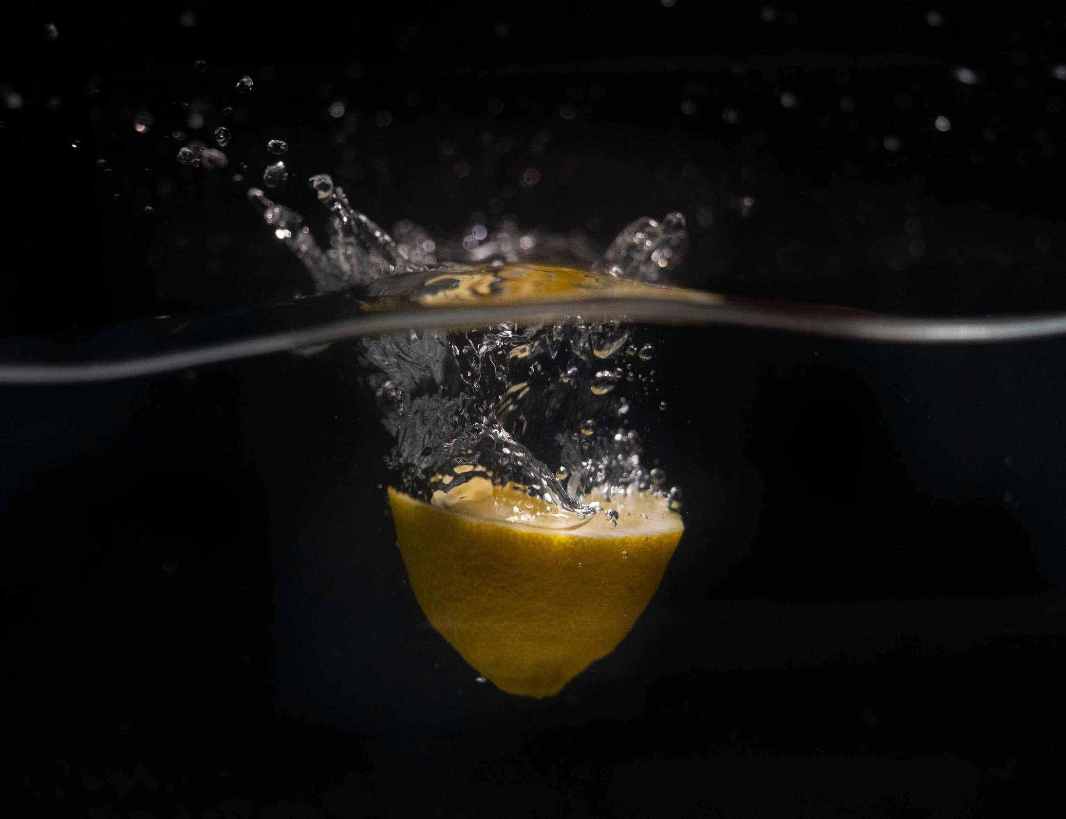 a lemon being dropped into the water, by Matthias Stom, pexels, photorealism, shot on hasselblad, short exposure, underwater shot, taken in the early 2020s