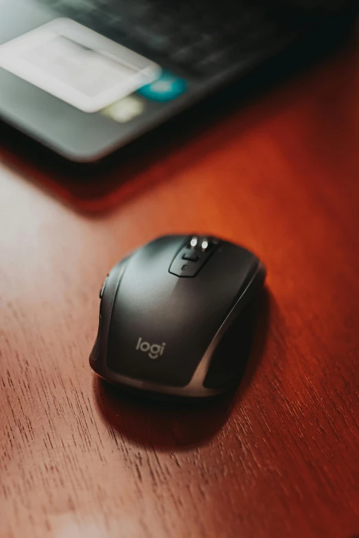 a computer mouse sitting on top of a wooden desk, in the center of the image, ign, product shot, f / 2 0