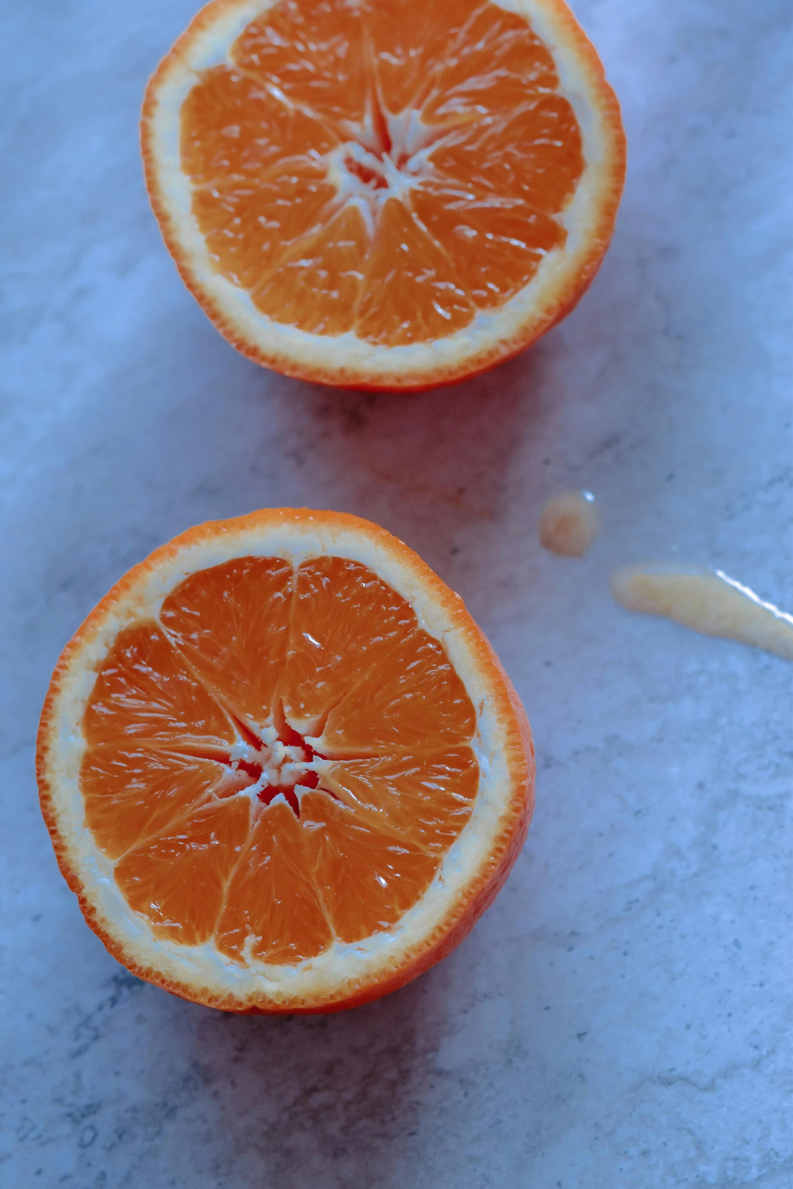 a couple of oranges sitting on top of a counter, caramel, soaking wet, crisp image, jaime jasso