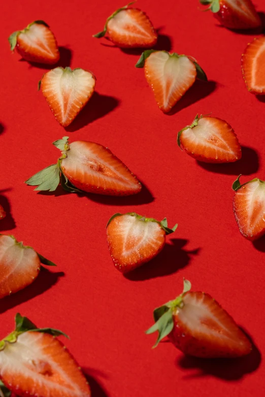 a bunch of strawberries sitting on top of a red surface, profile image