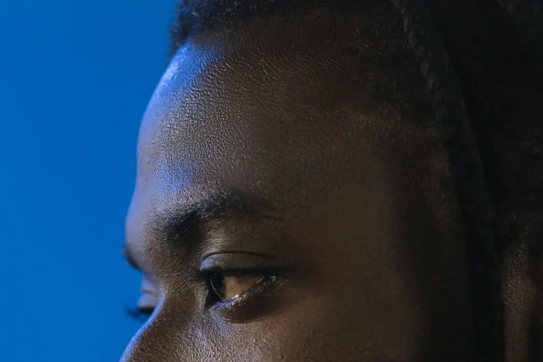 a close up of a person using a cell phone, an album cover, dark blue skin, contemplation, shot at dark with studio lights, emmanuel shiru